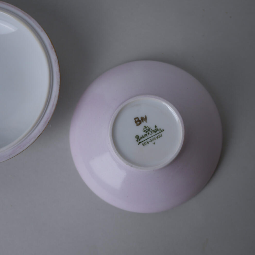 Upside-down pink porcelain teacup resting on a matching saucer, showing maker's mark on the bottom: BN, Rosenthal Selb Germany.